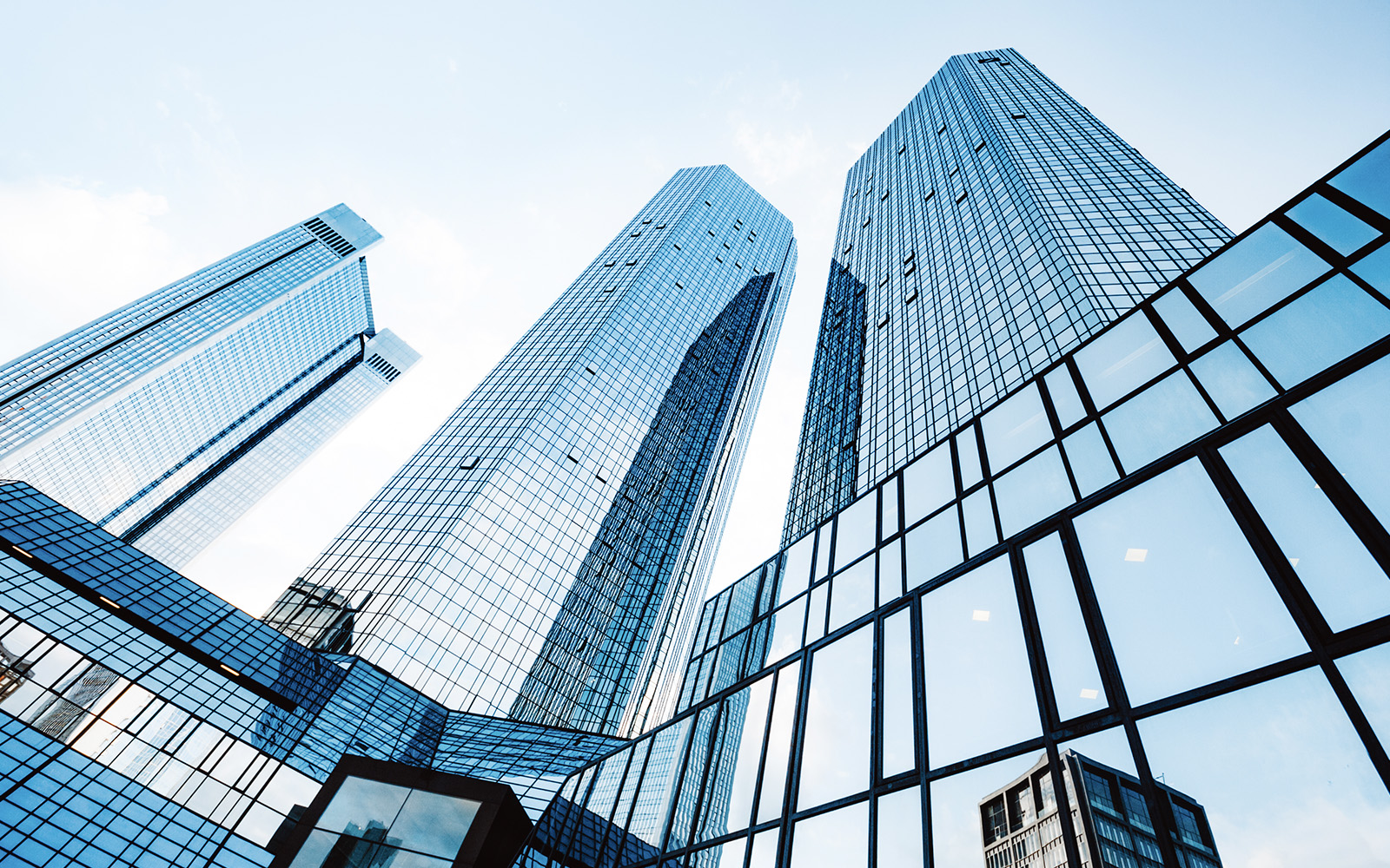 A perspective shot of a shiny and reflective enterprise business building, stretching tall into the sky