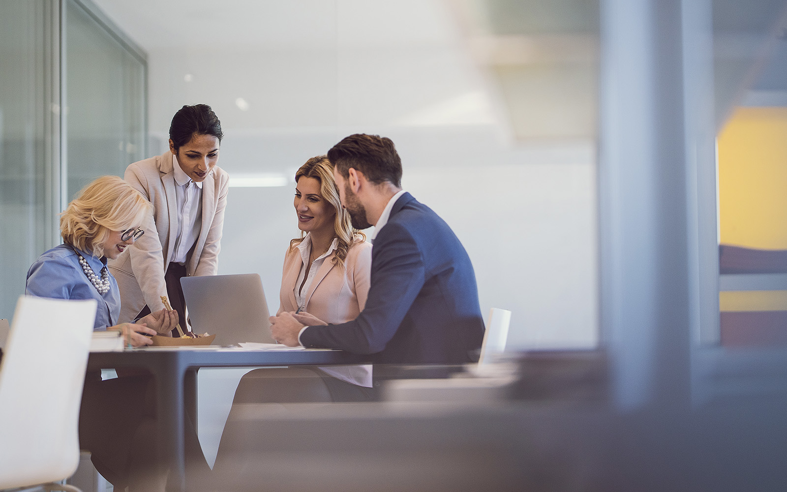 A group of business partners gathered around a small table.