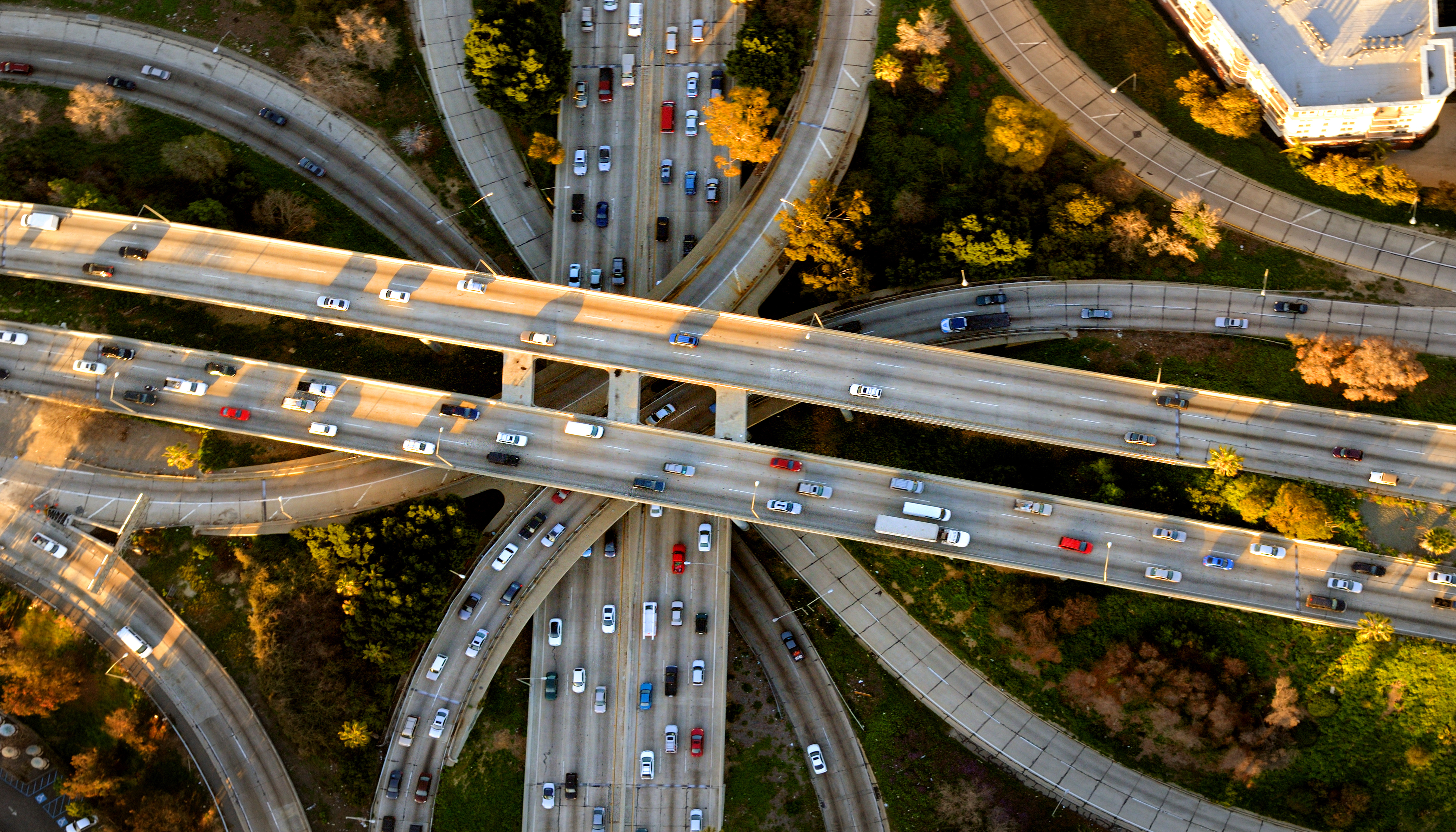 A highway, shot from above, with several cars in transit.
