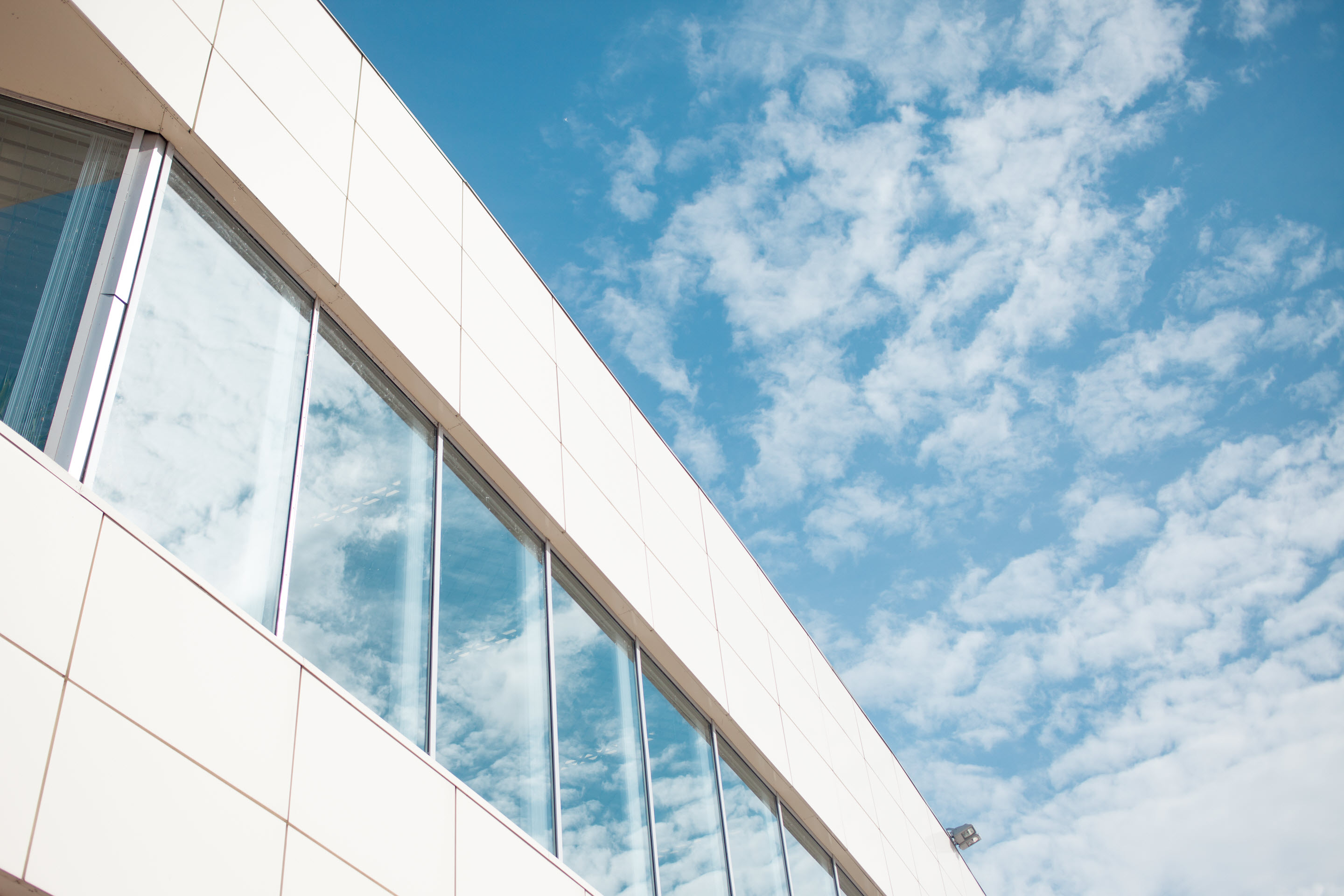 An image of an enterprise-level business against a blue sky with clouds.