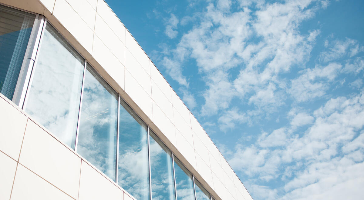 An image of an enterprise-level business against a blue sky with clouds.