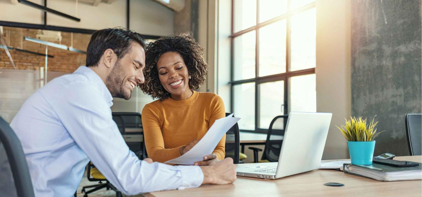 Two young business people having a successful meeting in modern office.