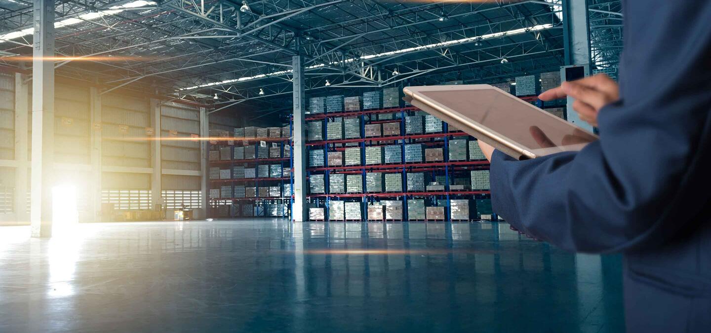 Businessman manager using tablet check and control for workers with Modern Trade warehouse logistics. Industry 5.0 concept