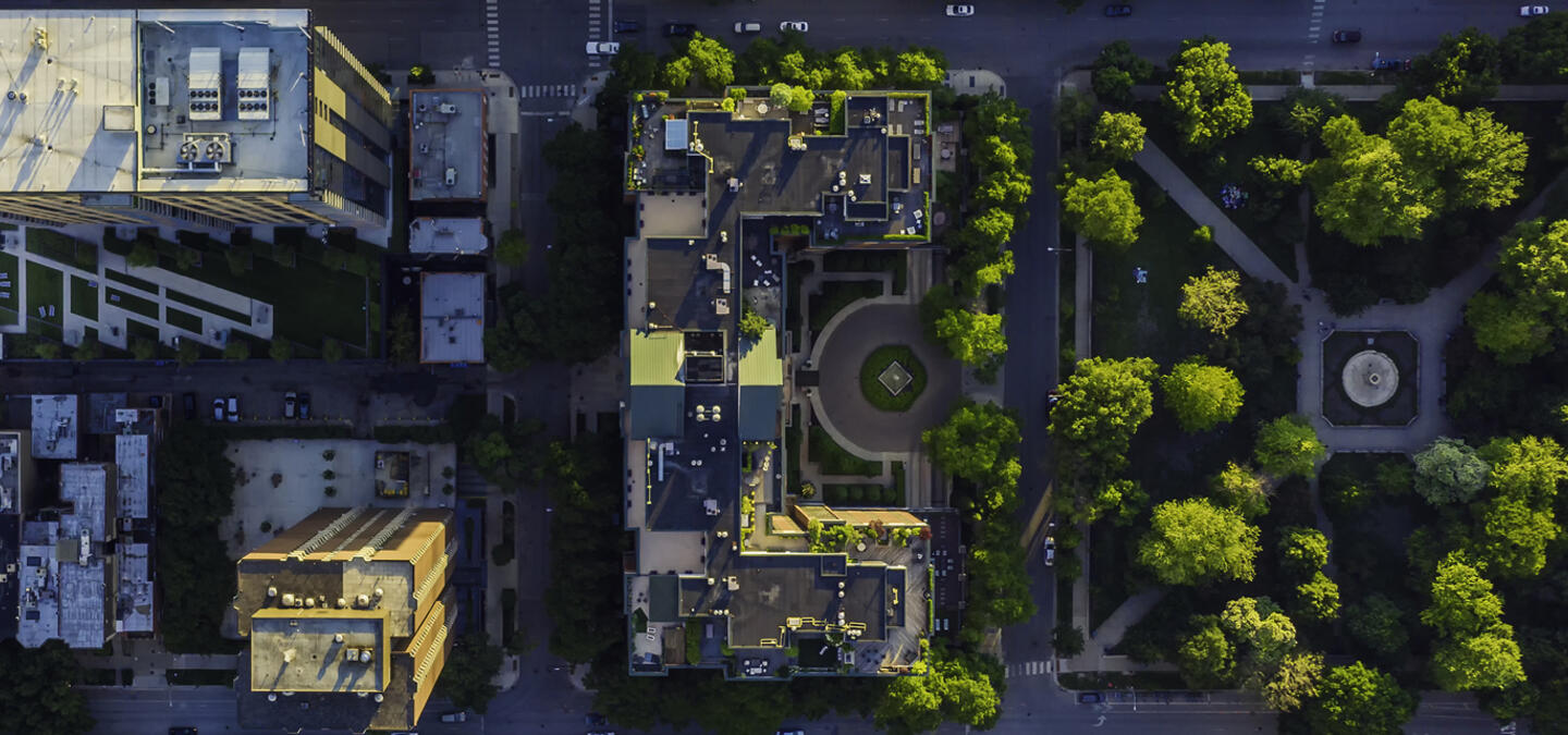 Vertex Inc. Partnerships Hero Background - A green cityscape of office buildings, taken from a bird's-eye view