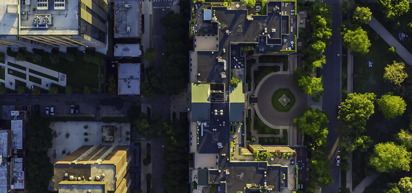 A birds-eye view of a city with plenty of greenery scattered throughout