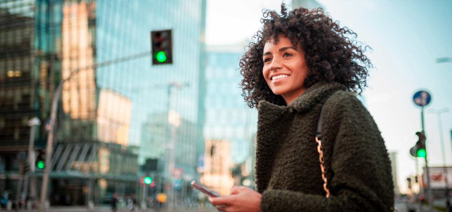 Woman in a city looking hopefully into the future