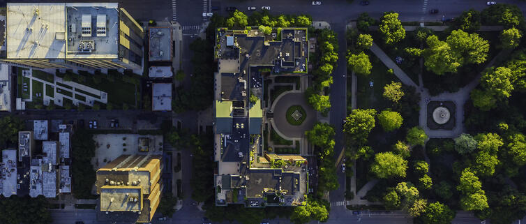 Vertex Inc. Partnerships Hero Background - A green cityscape of office buildings, taken from a bird's-eye view