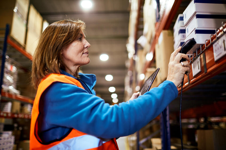 Woman checking stock in warehouse