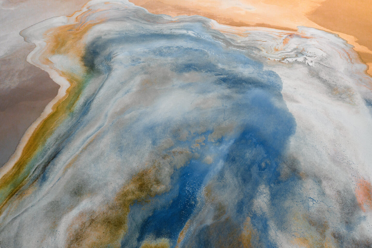 An abstract image of the Grand Canyon from above, blurring into shades of blue, orange, and white.