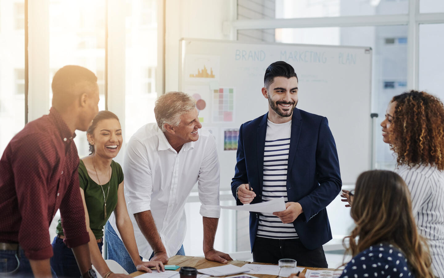 A group of business professionals gather around a table to collaborate on their latest project.