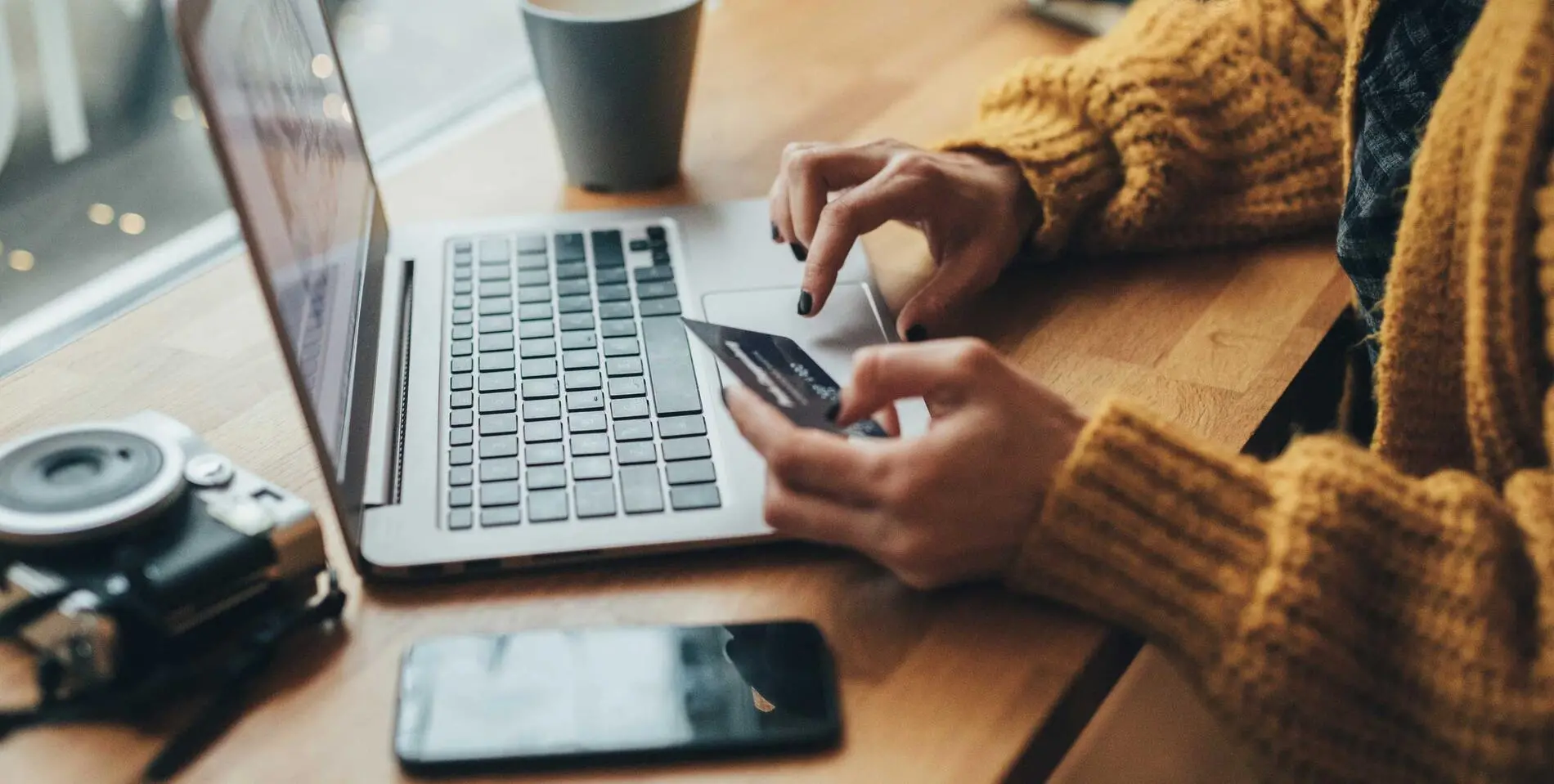 Woman in cafe shopping online with laptop