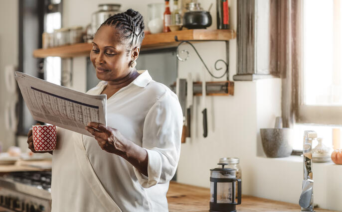 Woman reading the latest morning newspaper
