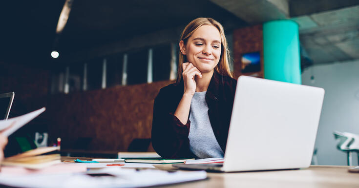 Businesswoman files her B2B tax returns through a streamlined online process using Vertex Express Returns, foregoing manual filing processes.