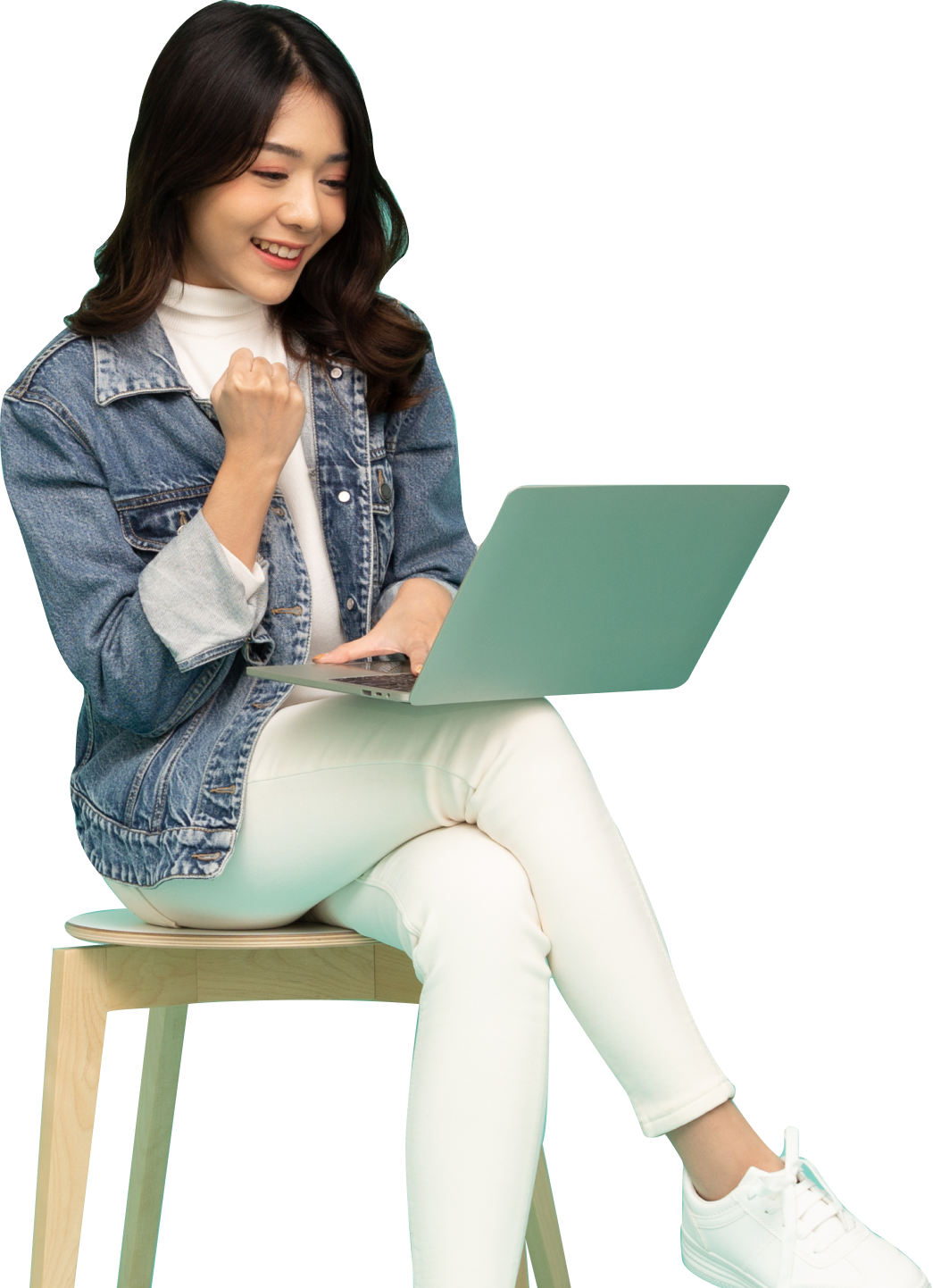 achieved woman sitting in chair looking at laptop